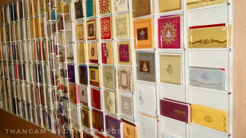 Gold, floral and colourful wedding invitations displayed at Thangam Wedding Cards