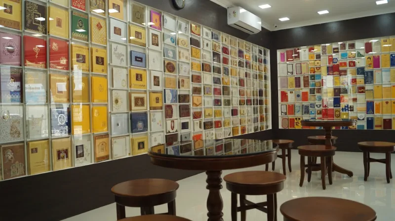 Thangam showroom with colourful invitation displays and tables for viewing designs